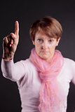 mature woman with a raised hand saying NO
