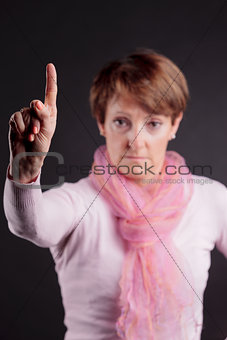 mature woman with a raised hand saying NO