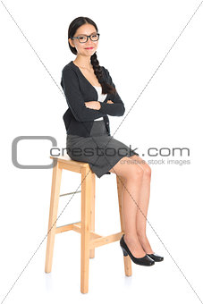 Asian female sitting on a chair
