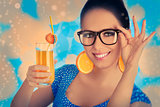 Girl with Orange Drink and Orange Slice Earrings Wearing Hat White Background
