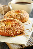 Breakfast. Sweet bagels with sesame seeds and coffee.