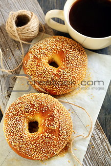Bagels with sesame seeds and black coffee. 