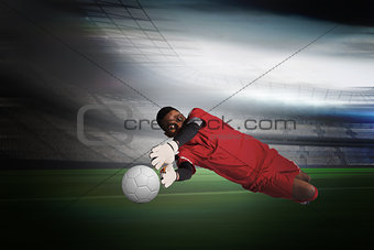 Goalkeeper in red making a save