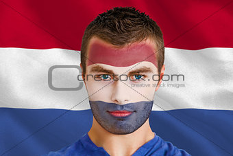 Serious young netherlands fan with facepaint