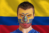 Serious young ecuador fan with facepaint