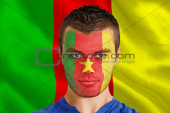 Serious young cameroon fan with facepaint