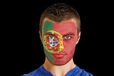 Serious young portugal fan with facepaint