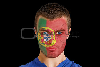 Serious young portugal fan with facepaint