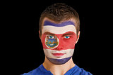 Serious young costa rica fan with facepaint