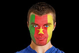Serious young cameroon fan with facepaint