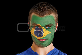 Serious young brasil fan with facepaint