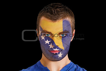 Serious young bosnian fan with facepaint