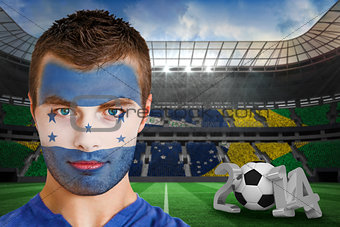 Serious young honduras fan with face paint