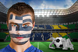 Serious young greece fan with face paint