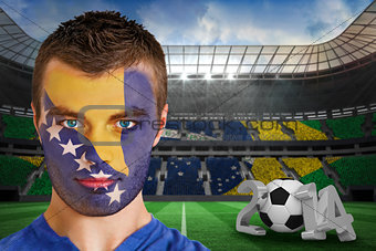 Serious young bosnia fan with face paint