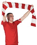 Football player holding striped scarf