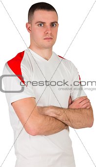 Handsome football player looking at camera
