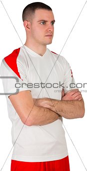 Handsome football player with arms crossed