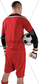 Goalkeeper in red holding the ball