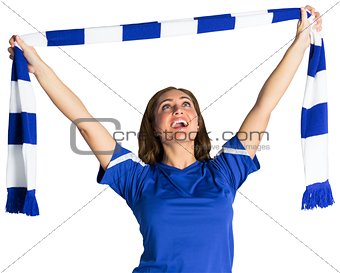 Pretty football fan waving scarf