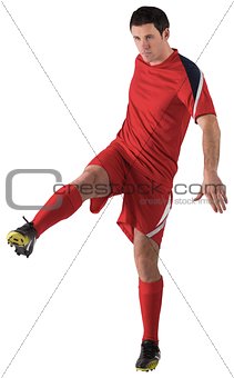 Football player in red kicking