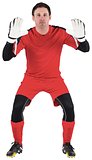 Goalkeeper in red ready to catch