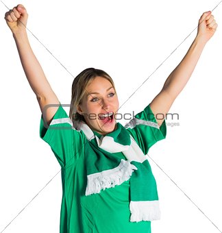 Cheering football fan in green jersey