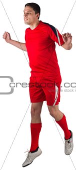 Fit football player jumping up