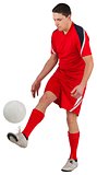 Fit young football player kicking