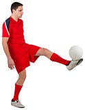 Fit young football player kicking