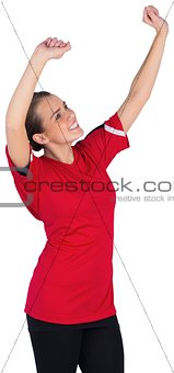 Excited football fan in red cheering