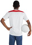 Football fan in white holding ball