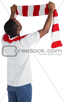 Happy football fan waving scarf