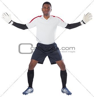 Goalkeeper in white ready to save