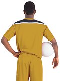 Football player in yellow holding ball