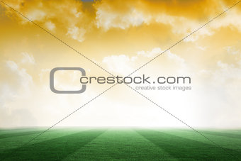Football pitch under yellow sky