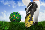 Football boot kicking brasil ball
