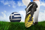 Football boot kicking greece ball