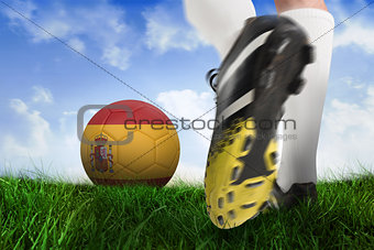 Football boot kicking spain ball