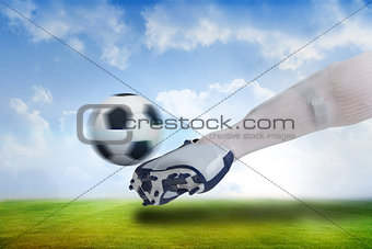 Close up of football player kicking ball