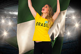 Excited football fan in brasil tshirt holding nigeria flag