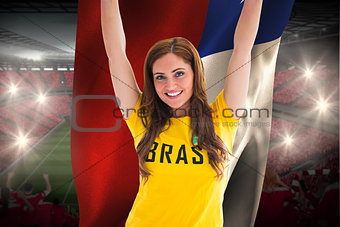Pretty football fan in brasil t-shirt holding chile flag
