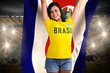 Excited football fan in brasil tshirt holding costa rica flag