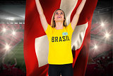 Excited football fan in brasil tshirt holding swiss flag