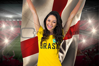 Excited football fan in brasil tshirt holding england flag