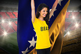 Excited football fan in brasil tshirt holding bosnia flag