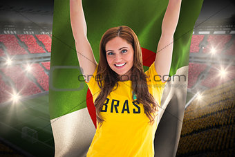 Pretty football fan in brasil t-shirt holding algeria flag
