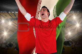 Excited football fan cheering holding iran flag