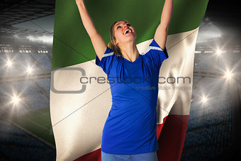 Cheering football fan in blue jersey holding italy flag