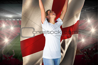 Pretty football fan in white cheering holding england flag
